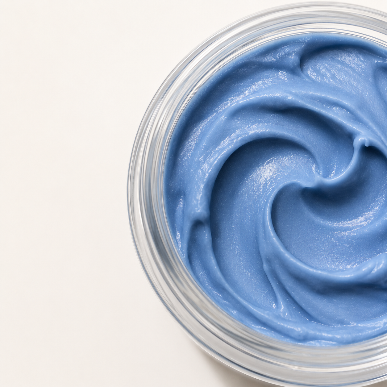 Close-up of Vellume's whipped periwinkle balm swirled in the jar
